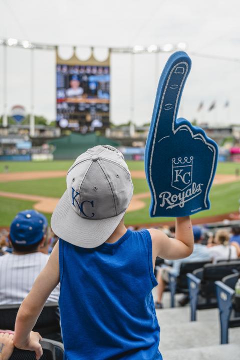 Kid cheering on the Kansas City Royals