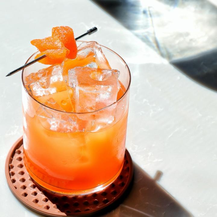 An orange-colored cocktail.
