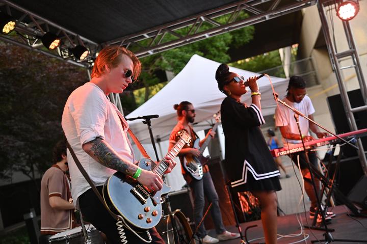 Band playing on an outdoor stage.