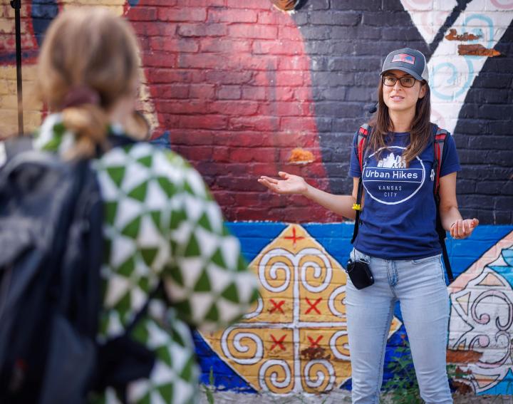 Lisa Pena in front of mural on urban hike
