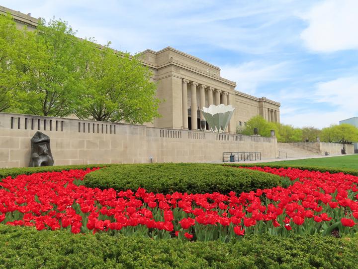 Front of Nelson-Atkins Museum of Art, with red flowers on the lawn.
