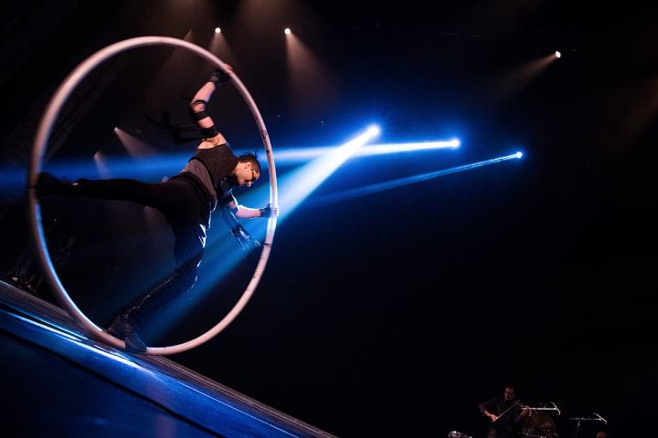 Acrobatic performer on stage in a large ring.