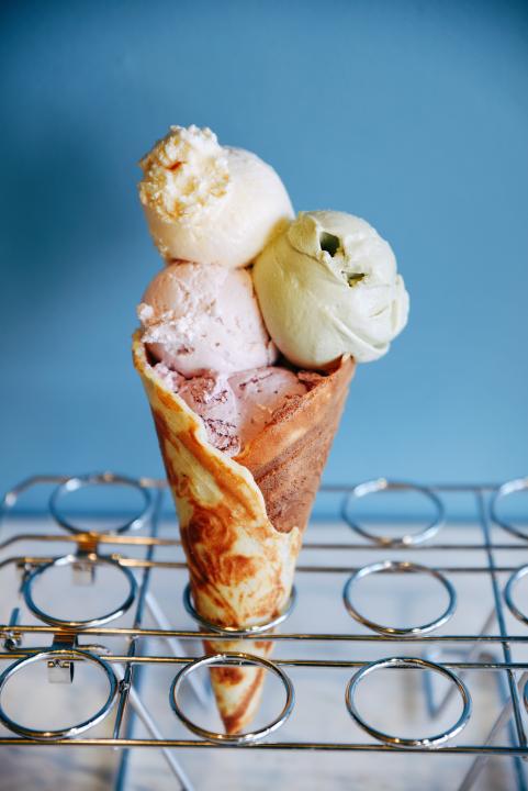 Three scoops of ice cream in a cone