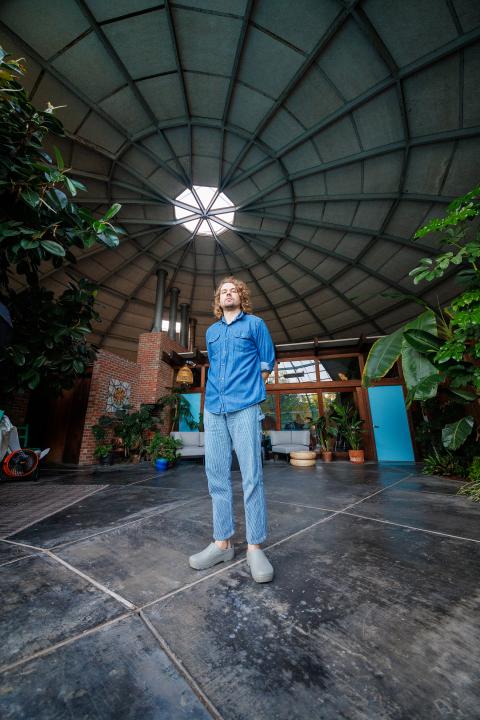 Kevin Morby standing in a large open room