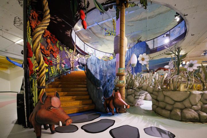 Open staircase decorated with jungle scenery and each step depicting a story line