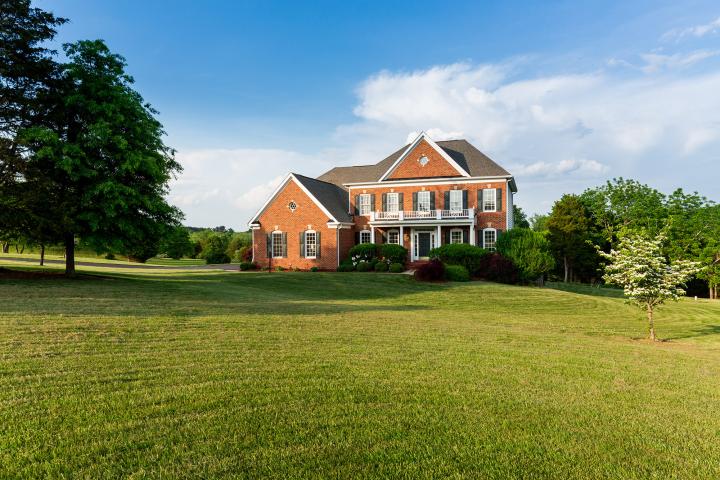 Large brick house on a scenic open area of land