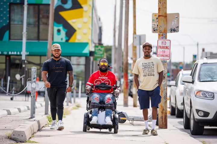 Will Smith and friends traversing downtown Kansas City together smiling