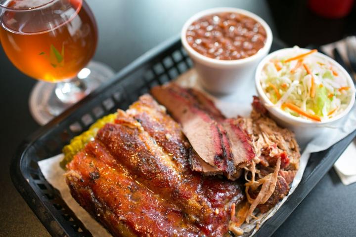 Serving of barbecued meat, coleslaw and beans with a glass of beer