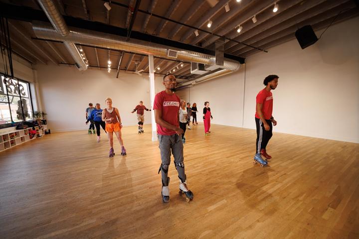 Co-owners of Sk8 SHOT Studios leading a roller skating class