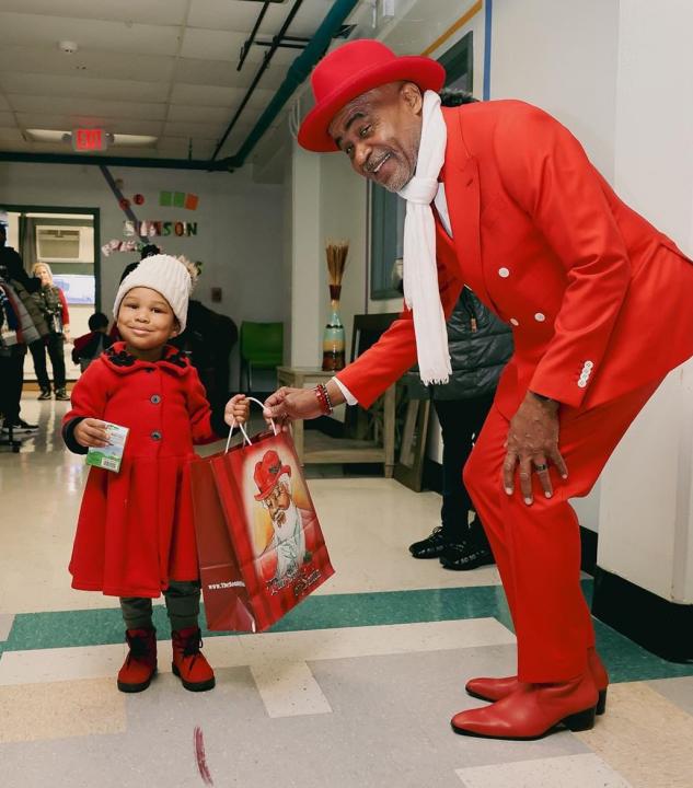 Lott handing young girl a gift