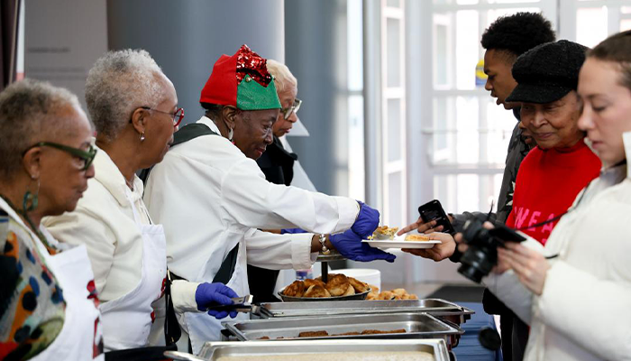 ladies dressed festively serving food