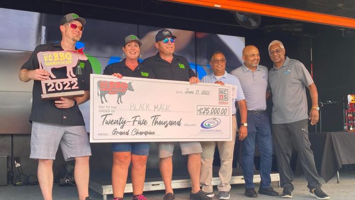 Smoke 'n Magic team holding large Made for KC BBQ Competition winning check