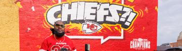 Will Smith in front of a Chiefs mural
