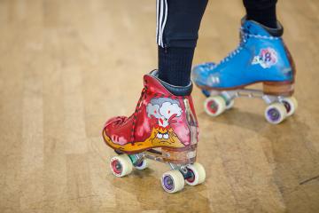 Someone wearing multi-Colored custom roller skates at Sk8 SHOT Studios