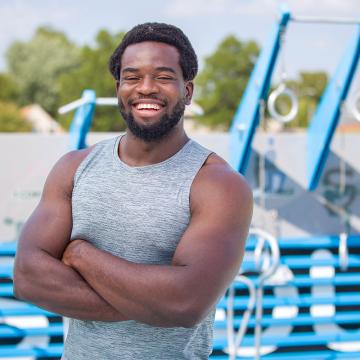 Godfrey Echekwu standing and smiling.